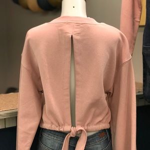 Salmon crop sweater. Open back. Tie close.